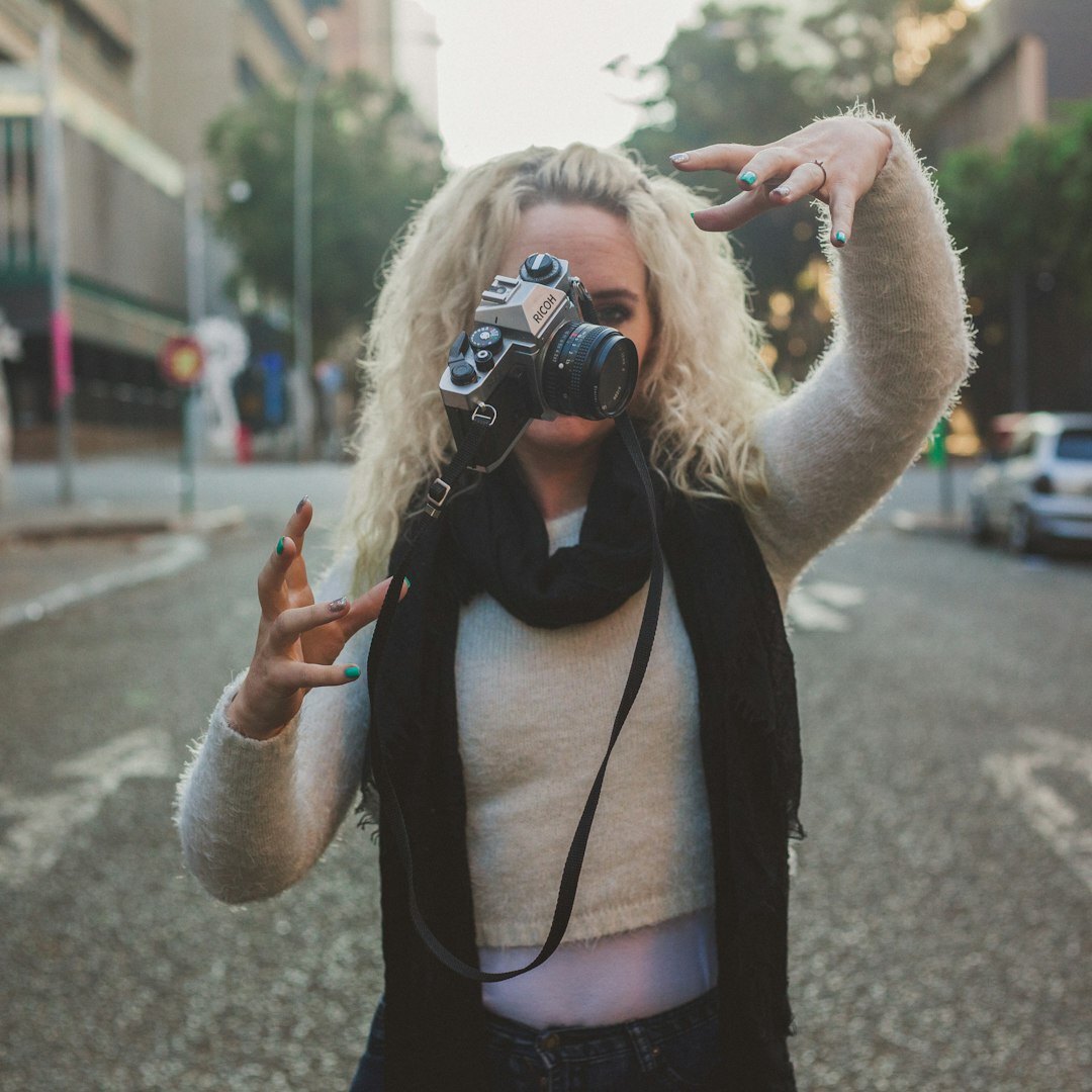 Video journalist filming with a smartphone on a gimbal in the city