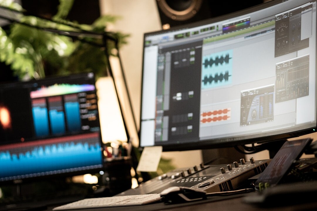 Video editing studio desk with multiple monitors showing footage timelines