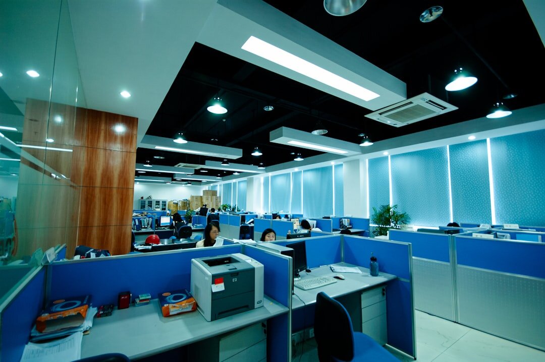 Modern newsroom office interior with desks and screens